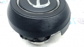 The Mazda CX-9 16-23 driver's steering wheel airbag is worn.