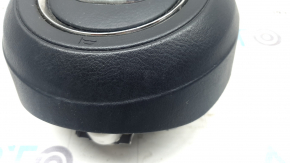 The Mazda CX-9 16-23 driver's steering wheel airbag is worn.