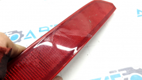 Right rear bumper reflector for Mazda CX-9 16-23 is cracked and worn.