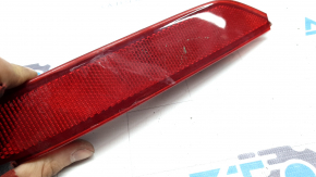 Right rear bumper reflector for Mazda CX-9 16-23 is cracked and worn.