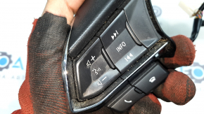 The steering wheel controls on a Mazda CX-9 (16-21) are worn.