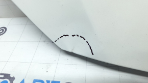 The upper grille cover of the Mazda CX-9 16-23 is dented, scratched, and worn.