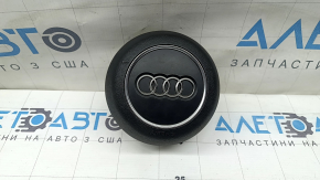 The steering wheel airbag for the driver's side of the Audi A4 B9 17-25 is black, with nicks in the chrome and scratches.