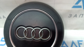 The steering wheel airbag for the driver's side of the Audi A4 B9 17-25 is black, with nicks in the chrome and scratches.