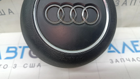 The steering wheel airbag for the driver's side of the Audi A4 B9 17-25 is black, with nicks in the chrome and scratches.