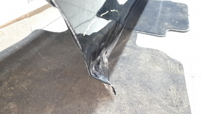 The bare rear right door of a BMW X7 G07 19-26 black 475 is dented.