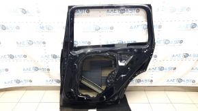 The bare rear right door of a BMW X7 G07 19-26 black 475 is dented.