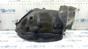 The front right rear fender liner of the BMW X7 G07 19-26 is dented and has tears.