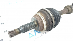 The front left drive axle shaft of a Toyota Camry V40 hybrid is rusty and the threads are dented.