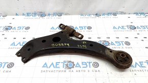 The front left lower control arm of a Toyota Camry v40 is rusty and the silent block is torn.