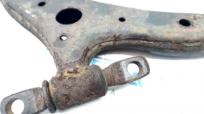 The front left lower control arm of a Toyota Camry v40 is rusty and the silent block is torn.
