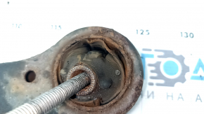 The front left lower control arm of a Toyota Camry v40 is rusty and the silent block is torn.