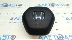 The Honda CRV 23-26 driver's steering wheel airbag is black, with a rusty squib cartridge and scratches.