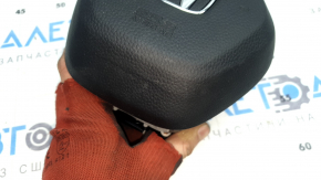 The Honda CRV 23-26 driver's steering wheel airbag is black, with a rusty squib cartridge and scratches.