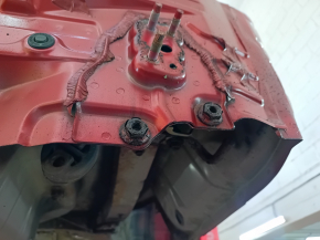 The rear panel of a Toyota Camry v40 is red and rusty, with a broken stud.