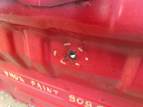 The rear panel of a Toyota Camry v40 is red and rusty, with a broken stud.