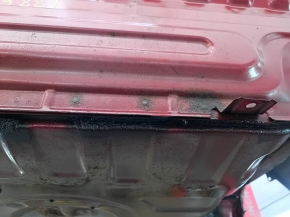 The rear panel of a Toyota Camry v40 is red and rusty, with a broken stud.