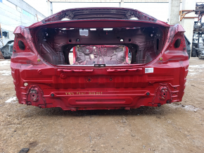The rear panel of a Toyota Camry v40 is red and rusty, with a broken stud.