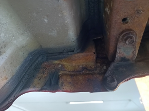 The rear panel of a Toyota Camry v40 is red and rusty, with a broken stud.