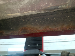 The right center pillar of a Toyota Camry v40 is rusty.