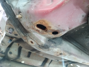 Front left quarter panel of Toyota Camry v40 on the body, red, rusty, painted