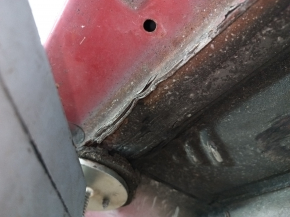 Front left quarter panel of Toyota Camry v40 on the body, red, rusty, painted