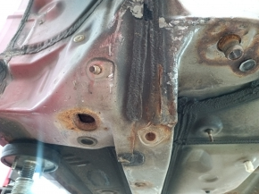 Front right quarter panel of a Toyota Camry v40, red, rusty, painted