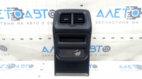 The center console trim with a deflector for a VW Tiguan 20-24 is black, worn, and has scratches.