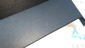 The center console trim with a deflector for a VW Tiguan 20-24 is black, worn, and has scratches.