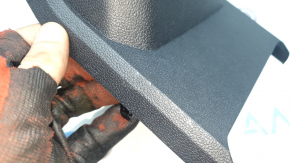 The center console trim with a deflector for a VW Tiguan 20-24 is black, worn, and has scratches.