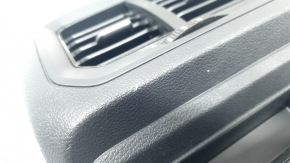 The center console trim with a deflector for a VW Tiguan 20-24 is black, worn, and has scratches.