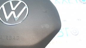 The driver's side airbag in the steering wheel of a VW Tiguan 22-24 is black and the plastic has turned white.