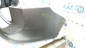 The rear bumper is bare, the upper part is white, the fasteners are cracked.