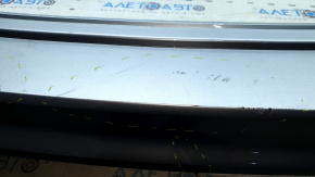 The rear bumper is bare, the upper part is white, the fasteners are cracked.