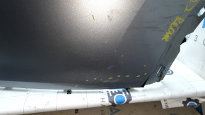 The rear bumper is bare, the upper part is white, the fasteners are cracked.