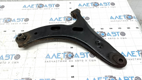 The lower front right control arm of a Subaru Forester 19-24 SK is rusty, with microcracks.
