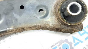 The lower front right control arm of a Subaru Forester 19-24 SK is rusty, with microcracks.