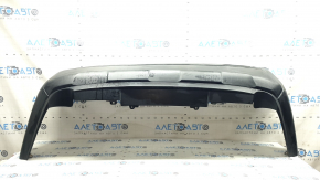 The bare lower part of the rear bumper of a Toyota Rav4 19-24 without parking sensors. The structure, scratches, sand, and whitened plastic are visible.