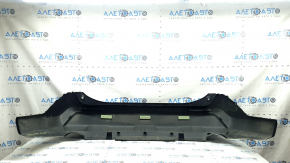 The bare lower part of the rear bumper of a Toyota Rav4 19-24 without parking sensors. The structure, scratches, sand, and whitened plastic are visible.