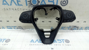 The steering wheel controls on a Toyota Rav4 19-23 without a heated steering wheel, black trim, and scuff marks.