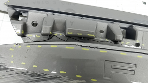 The Subaru Forester 25-26 trunk lid trim is broken, cracks, scratches, broken fasteners, a fragment is missing