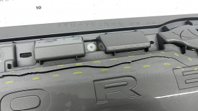 The Subaru Forester 25-26 trunk lid trim is broken, cracks, scratches, broken fasteners, a fragment is missing