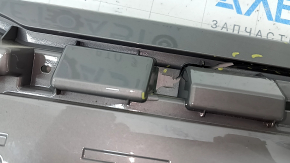 The Subaru Forester 25-26 trunk lid trim is broken, cracks, scratches, broken fasteners, a fragment is missing