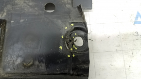 The left fuel tank guard for a Subaru Forester 25-26 is dented and torn.