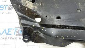 The left fuel tank guard for a Subaru Forester 25-26 is dented and torn.