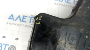 The left fuel tank guard for a Subaru Forester 25-26 is dented and torn.