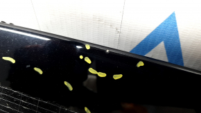 The hood of a Ford Explorer 20-25 is bare, black, UM, and has chips and glue on it.