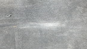 The trunk floor of a Ford Explorer 20-25 is black, worn, scratches on the handle, and a tear.