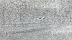 The trunk floor of a Ford Explorer 20-25 is black, worn, scratches on the handle, and a tear.