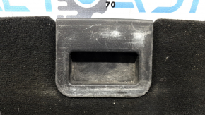 The trunk floor of a Ford Explorer 20-25 is black, worn, scratches on the handle, and a tear.